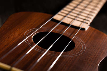 Close up of ukulele on old wood background.の写真素材