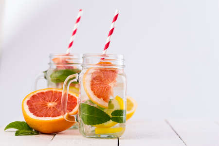 Summer detox drink with fresh fruits in glass jar.の写真素材