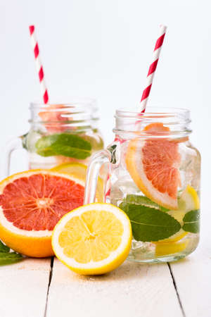 Summer detox drink with fresh fruits in glass jar.の写真素材