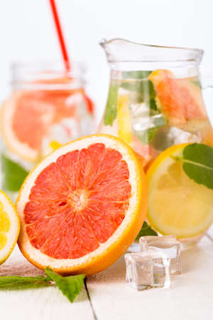 Summer detox drink with fresh fruits in glass pitcher.の写真素材