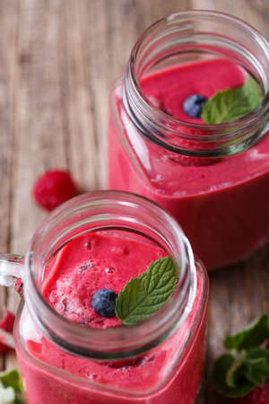 Top view on delicious rasberrie smoothie in glass jar.の写真素材