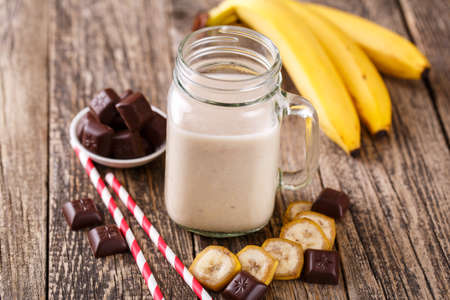 Healthy banana with chocolate smoothie in glass jar.の写真素材