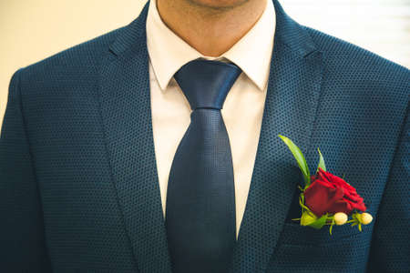 Groom's suit for wedding day with boutonniere and tie.の写真素材