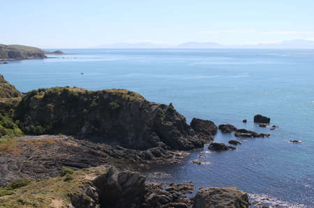 Calm ocean mountains in the distanceの写真素材