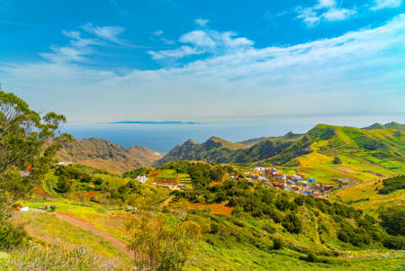 Panoramic landscape of Anaga mountains and ocean. Grand Canaria island on the horizon. Blue sky with...