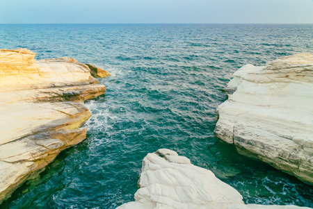White stones or rocks beach on Cyprus. A view of a sea shore. White rocks and stone coast.の写真素材