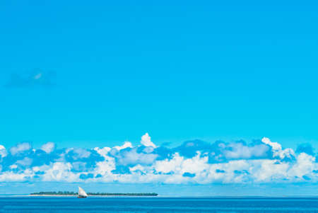 Fishing ship in water of Indian ocean in front of small island. Zanzibar, Tanzania.