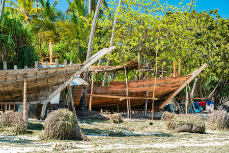 Wooden boat construction site on beach of Nungwi, Zanzibar, Tanzania.