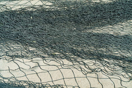 Close up of Fishing net dry on a sandy beach. Zanzibar, Tanzania.の写真素材