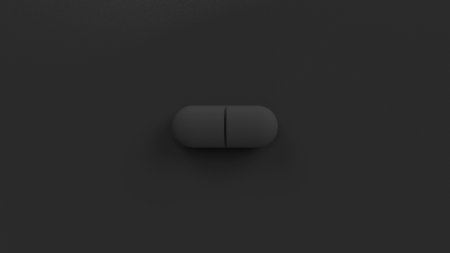 Black single pill isolated on a black background. Tablet, pill top view, flat lay. 3d render illustrationの写真素材