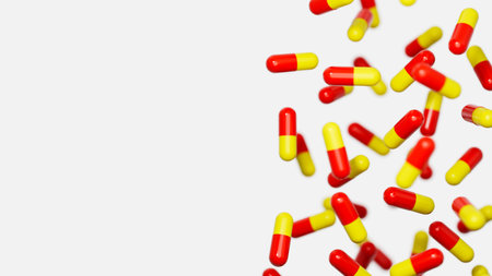 Red orange medicine capsules floatimg against white backdrop with a place for text. Medical research, science concept. 3d render illustration.の写真素材