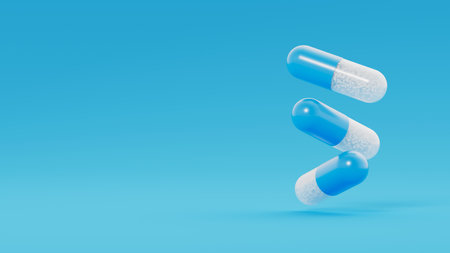 Three blue transparent capsules, pills with white granules inside float on blue background. Medicinal treatment, tablet, cure concept. Place for text. 3d render illustrationの写真素材