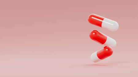 Three red white capsules, pills float on light red background. Medicinal treatment, tablet, cure concept. Place for text. 3d render illustrationの写真素材