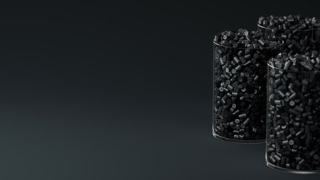 Side view on three glasses with black plastic polypropylene granules, masterbatch polymer grain, on...
