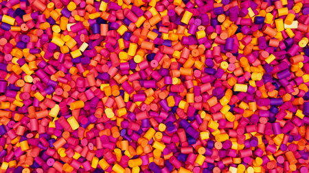 Closeup top view of colorful mixed plastic polypropylene granules, masterbatch polymer grain. HDPE...