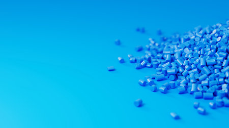 Closeup side view on blue plastic polypropylene granules heap on blue backdrop with shallow DOF,...