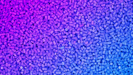 Closeup top view on piles of colorful violet to blue plastic polypropylene granules, masterbatch...