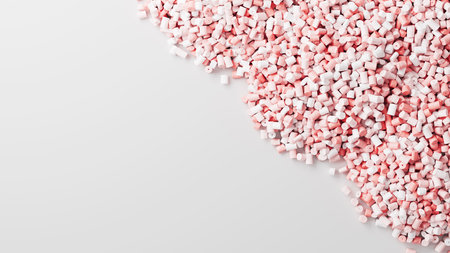 Closeup top view on pink plastic polypropylene granules heap on white backdrop, masterbatch polymer grain pile. HDPE or PVC resin pellets. 3d render illustrationの写真素材