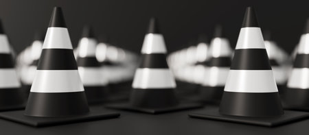 Front view on grid of Traffic cones with shallow dof on black background. Safety warning or under...