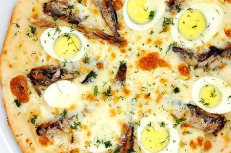 pizza close up with a fish on a white backgroundの写真素材