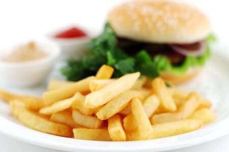 Cheeseburger with vegetables and a potato on a white backgroundの写真素材