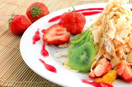 Salad from fruit and berries close up on a straw napkinの写真素材