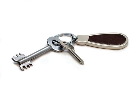 Two keys on a charm. It is isolated on a white backgroundの写真素材