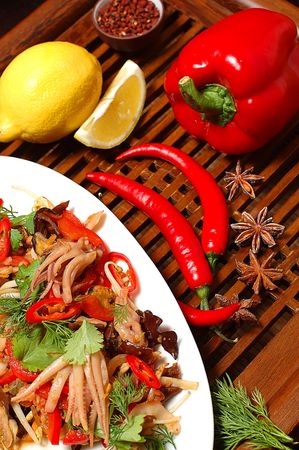 Sharp salad from shrimps on a wooden supportの写真素材