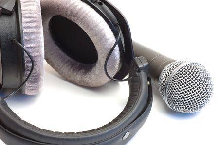 Modern scenic microphone and professional ear-phones on a white backgroundの写真素材