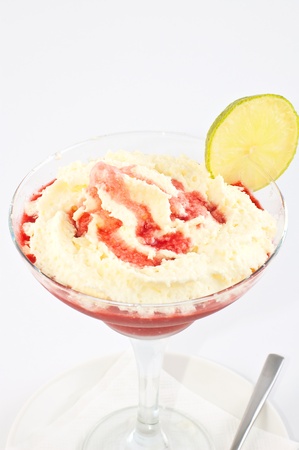 Dessert ice-cream with a lemon and liquor in a vase on a long leg on a white backgroundの写真素材