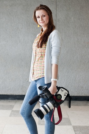 The woman the reporter with a professional videocamera and a supportの写真素材