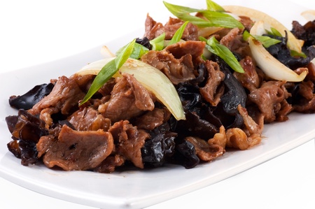 Stewed meat with vegetables on a white square plateの写真素材