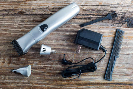 portable trimmer with attachments on a wooden table top viewの写真素材