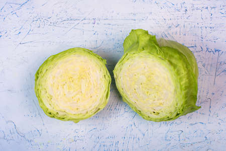 cut green cabbage roach on a white table. view from above.の写真素材