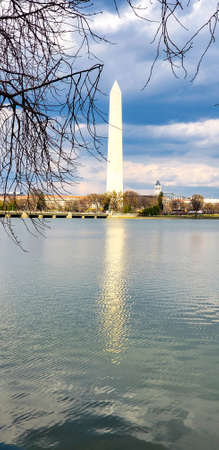 Washington DC USA. 2 april 2020.washington monument against the blue sky with reflection in the water of the lakeのeditorial素材