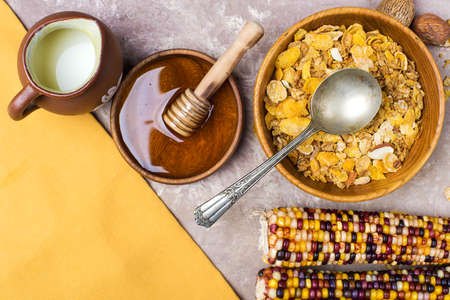 Wooden bowl full of slaks with honey and milk. View from above.