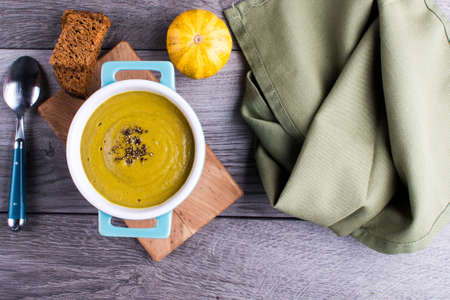 Broccoli and pumpkin cream soup with crackers on a table. Classic European food. Close-up shot. view...
