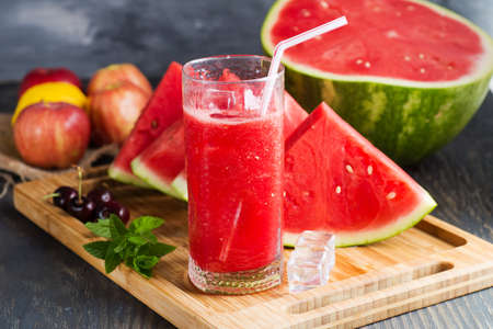 Fresh watermelon juice with ice in a glass. Slices of watermelon on the table.Fresh watermelon juice with ice in a glass. Slices of watermelon on the table.の写真素材