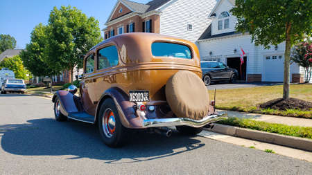 Leesburg. Virginia, USA August 14, 2021. Ford Model 40 Sedan 1934 is parked by the side of the road on a sunny day.back view.のeditorial素材
