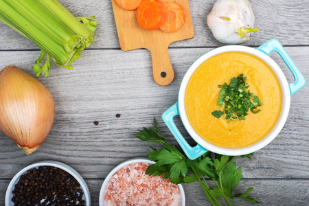 composition of vegetable puree soup and ingredients on the table. view from above. healthy food.の写真素材