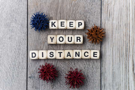 KEEP YOUR DISTANCE - lettering from cubes on a gray background.の写真素材