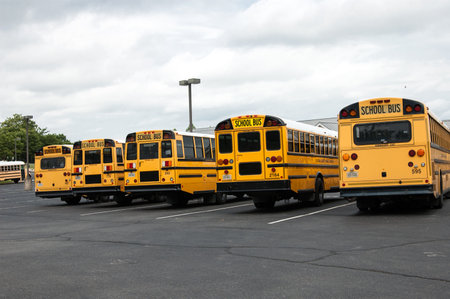 Leesburg. Virginia, USA. June 9, 2022. Yellow School Buses are parked in a row in a special parking lot near the school.のeditorial素材