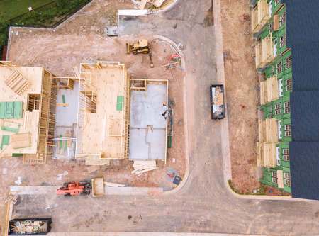 Front view of a large brick country house. Large freshly cut lawn and trees in the foreground.の写真素材