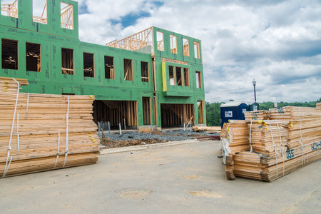 Front view of a large brick country house. Large freshly cut lawn and trees in the foreground.のeditorial素材