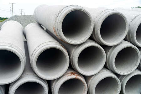 new concrete pipes stacked on a construction site. Preparation for the manufacture of the sewer system.の写真素材