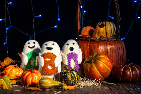 Festive Halloween image. Pumpkins, autumn leaves, boo dolls. The concept of horror stories and holiday.の写真素材