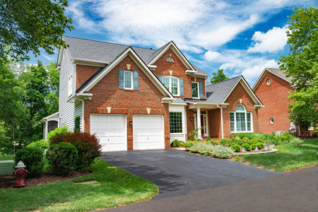 Leesburg. Virginia. USA. August 15, 2022. Landscape with a large country house. Large mowed lawn and blue sky.