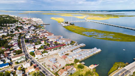Chincoteague Island, marinas, houses and motels with parking lots. bridge and road along the bay....