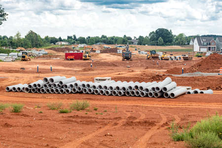 set of new pipes stacked on construction site.