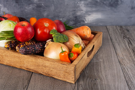 Fresh fruits and vegetables in a wooden box. New harvest and autumn time.の写真素材